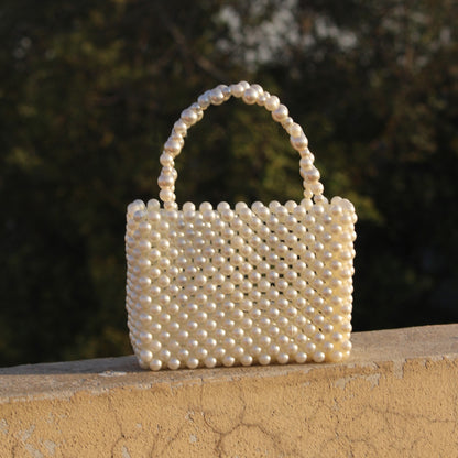 Handcrafted pearl beaded handbag with an elegant and timeless design—perfect for formal events and fashion-forward styling.